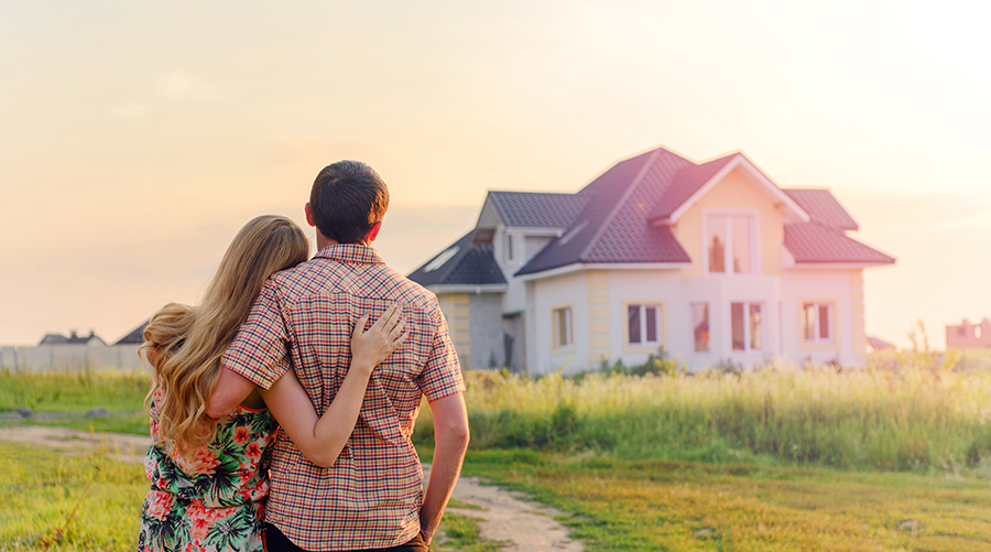 Young couple looking at jumbo loan dream home